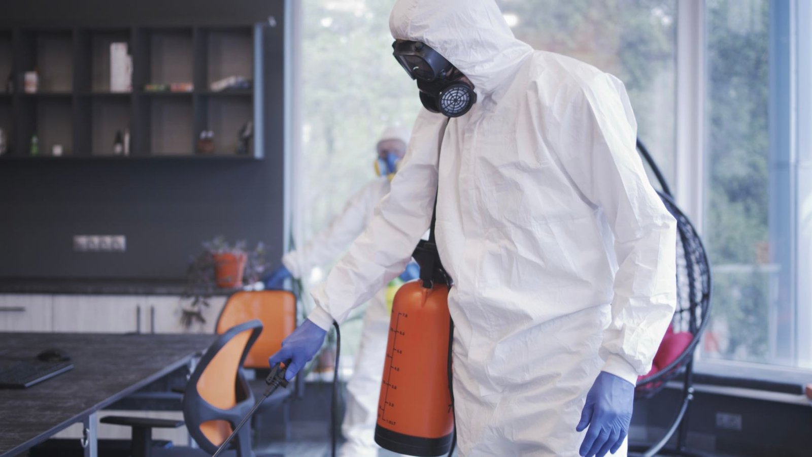 Technicians in full PPE performing decontamination work