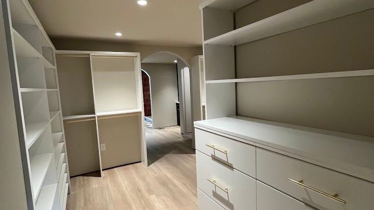 Walk-in wardrobe with shelving, drawers and floor cleaned to White Glove standard