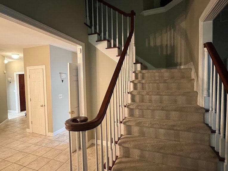 Cleaned entryway, tile floor and staircase in a family home