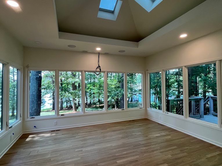 Sunroom with hardwood floor cleaned after construction work