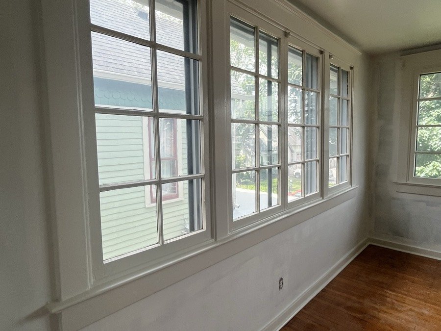 Sunroom windows and hardwood floor in an empty home ready for handover